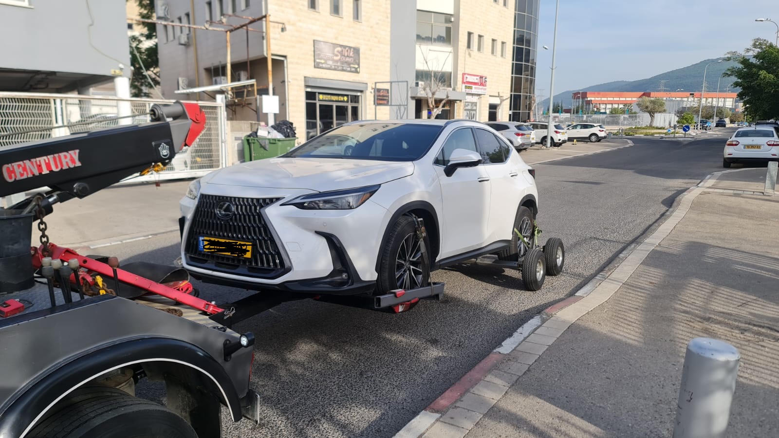 רכב לקסוס לבן מורם על דולי גרירה